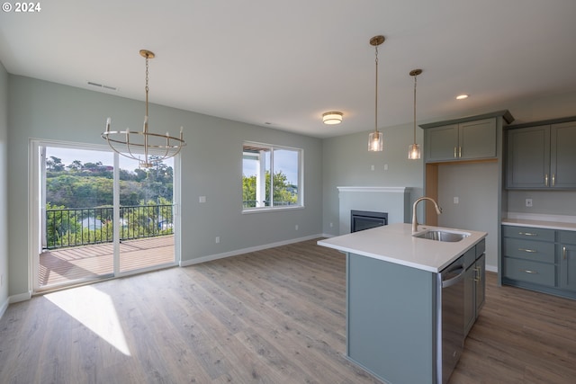 kitchen with stainless steel dishwasher, gray cabinetry, visible vents, and a sink