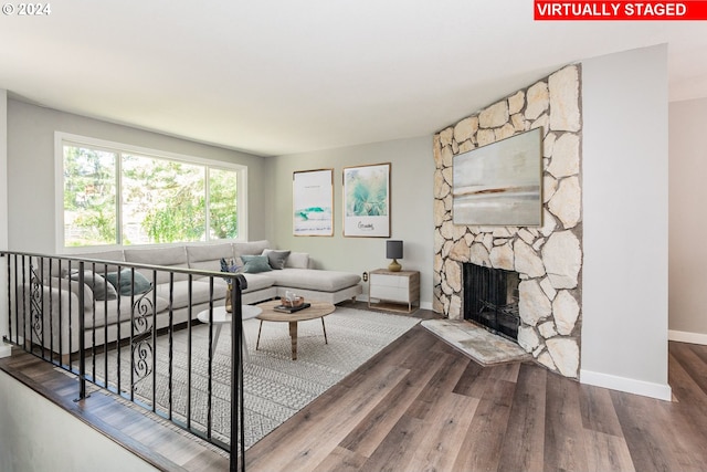 living room featuring wood-type flooring and a fireplace