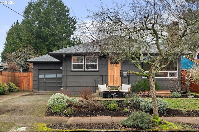 view of front of house with a garage and a patio area