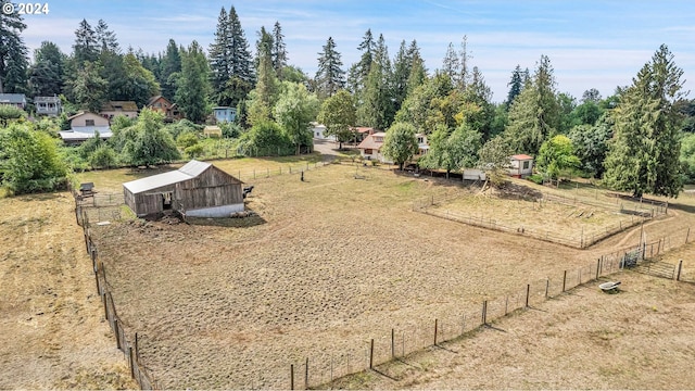 view of yard featuring an outdoor structure and a rural view