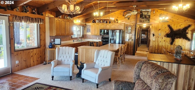 kitchen featuring a notable chandelier, a center island, sink, and a wealth of natural light