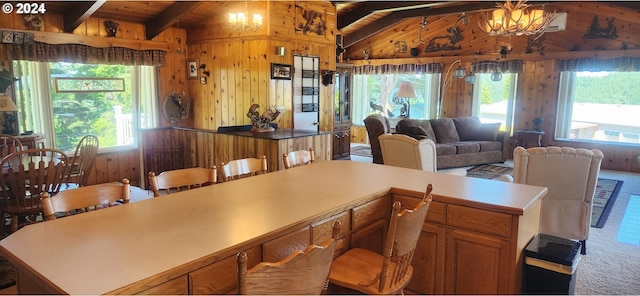 kitchen featuring an inviting chandelier, lofted ceiling with beams, wood walls, carpet floors, and wood ceiling