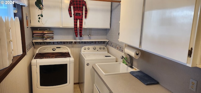 laundry area with cabinets and washing machine and clothes dryer