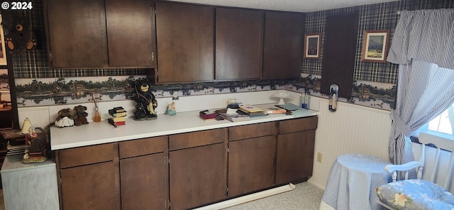 interior space with dark brown cabinetry and a textured ceiling