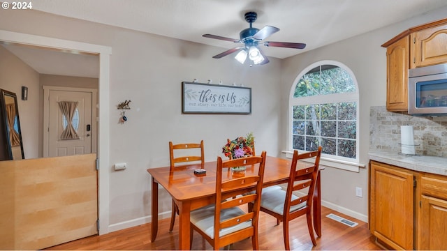 dining area featuring ceiling fan and light wood-type flooring