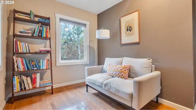 living area with hardwood / wood-style flooring