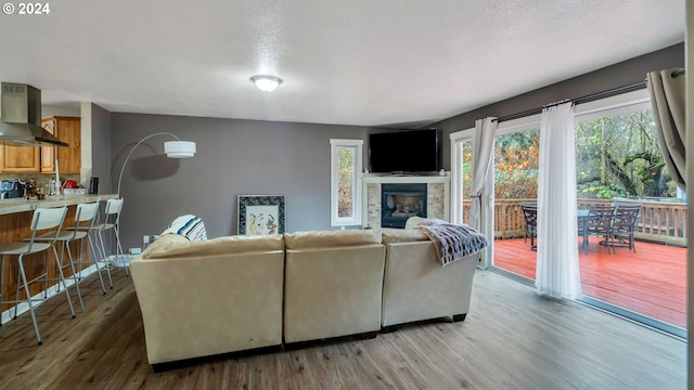 living room featuring a textured ceiling and light wood-type flooring