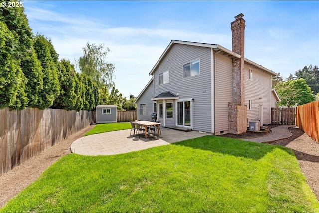 back of property with a storage unit, a chimney, central AC unit, an outdoor structure, and a patio