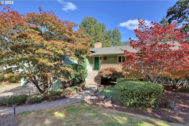 obstructed view of property featuring covered porch and a garage