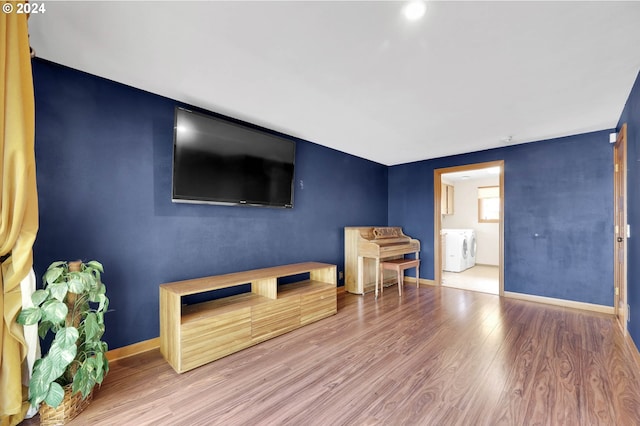 interior space with washing machine and dryer and hardwood / wood-style floors