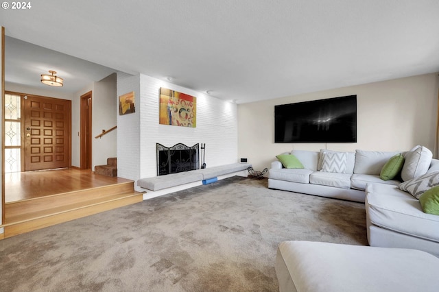 living room featuring a brick fireplace and carpet