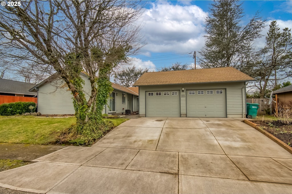 single story home with a garage and a front yard