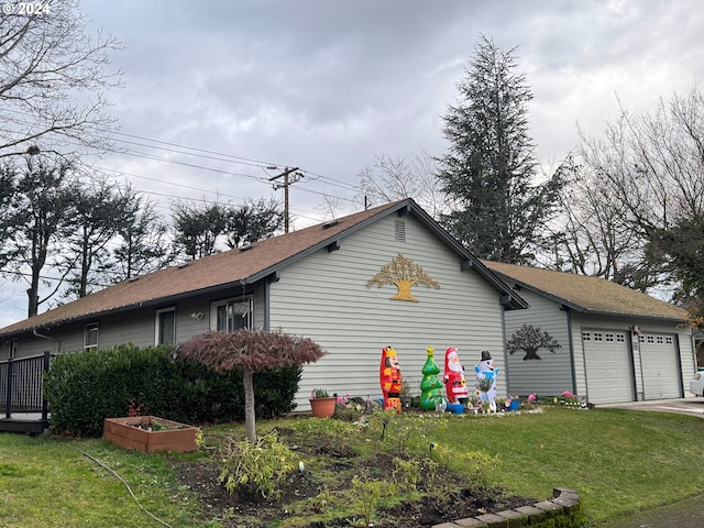 view of property exterior with a garage and a yard