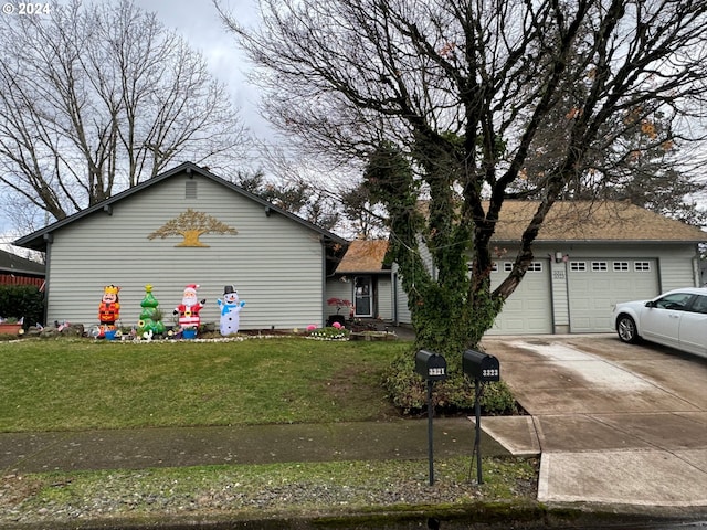 view of front of house featuring a front lawn and a garage