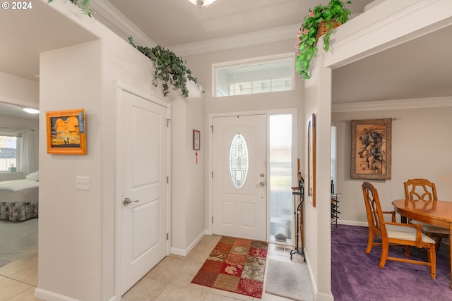 foyer entrance featuring crown molding and light tile patterned flooring