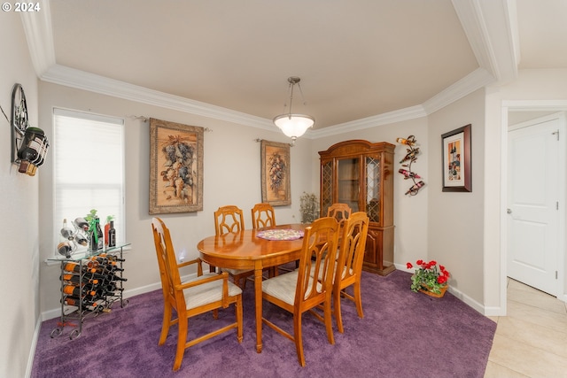 dining room featuring crown molding, baseboards, and tile patterned flooring