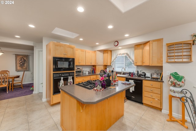kitchen featuring dark countertops, light brown cabinets, a center island, and black appliances
