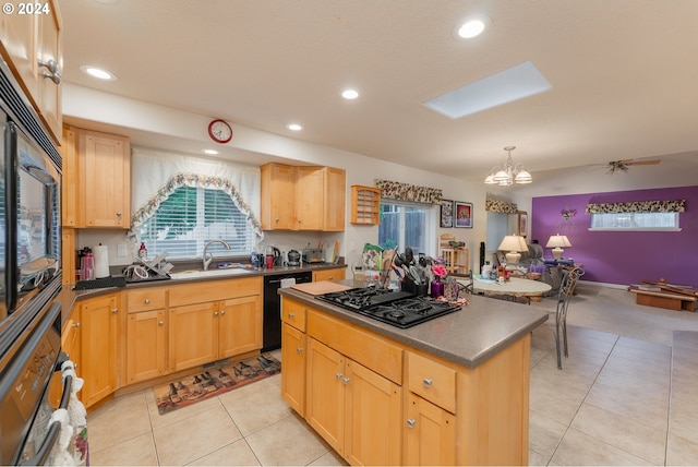 kitchen featuring a kitchen island, dark countertops, a sink, black appliances, and recessed lighting