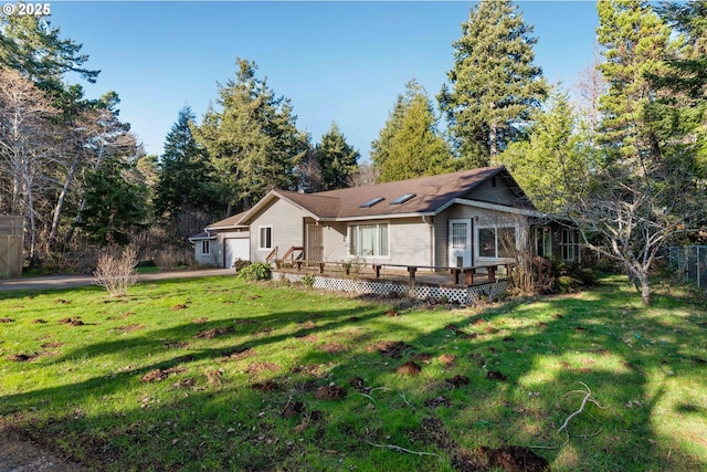 rear view of property with a lawn and a deck