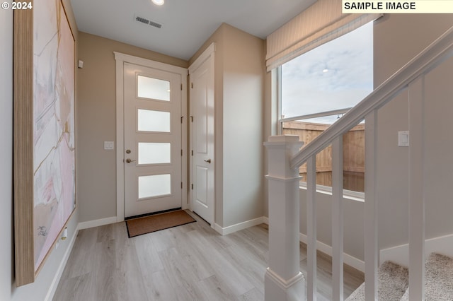 entrance foyer featuring baseboards, visible vents, and light wood-style floors