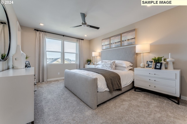 bedroom featuring ceiling fan and light carpet