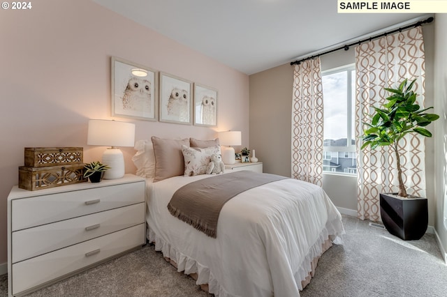 bedroom with baseboards and light carpet