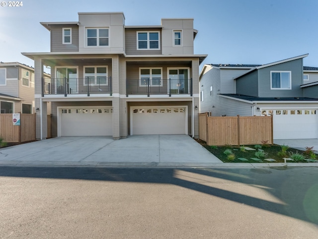 view of front facade featuring a balcony and a garage