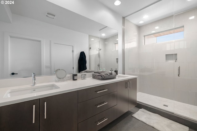 bathroom with vanity and a shower with shower door