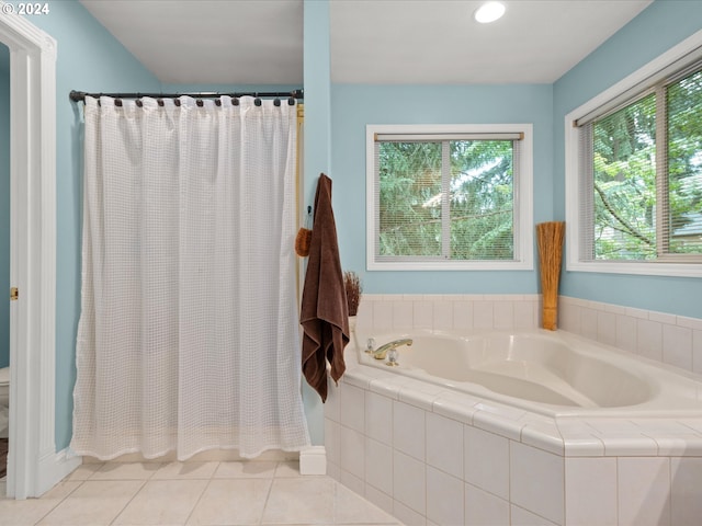 bathroom with independent shower and bath and tile patterned floors