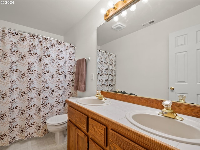 bathroom featuring vanity, curtained shower, and toilet