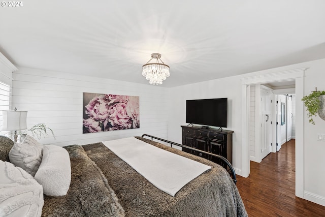 bedroom featuring dark wood-type flooring and a notable chandelier