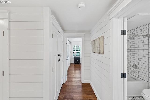 hallway with dark hardwood / wood-style flooring