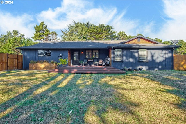 back of house with a yard and a wooden deck