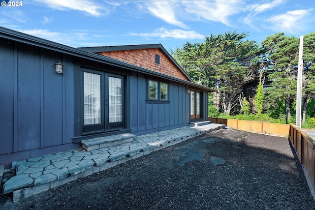 view of side of property featuring french doors and a patio