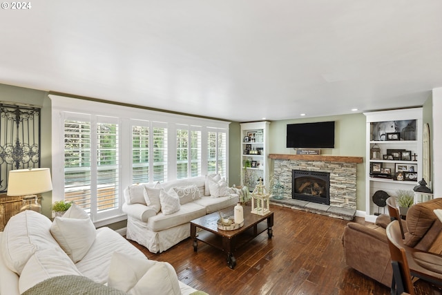 living room featuring a fireplace, built in shelves, and dark hardwood / wood-style floors