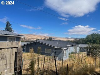 3214 W 10th St, The Dalles, OR 97058 - rear view of property with fence
