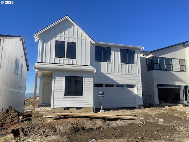 rear view of property with a garage