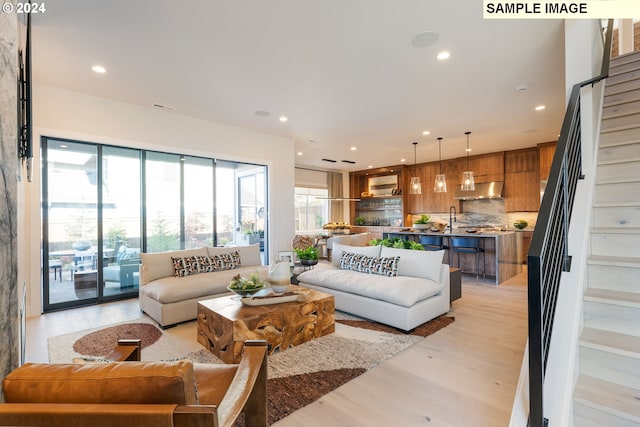 living area featuring stairway, recessed lighting, a healthy amount of sunlight, and visible vents