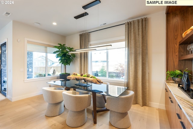 dining space with light hardwood / wood-style floors and a wealth of natural light