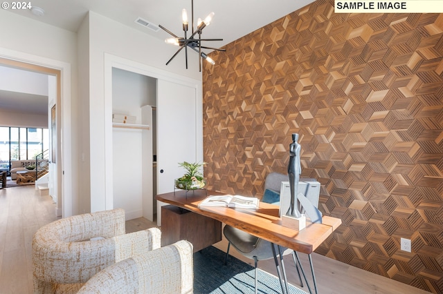 home office featuring an inviting chandelier and wood-type flooring