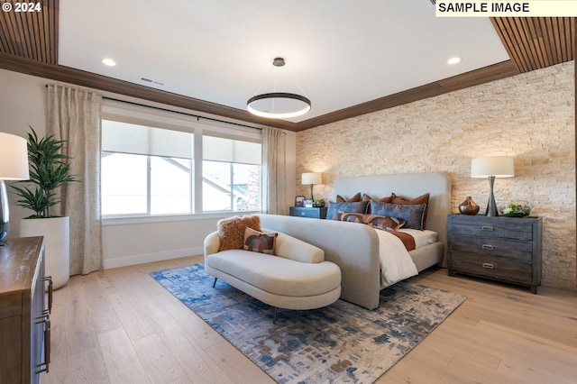 bedroom with ornamental molding and light hardwood / wood-style flooring