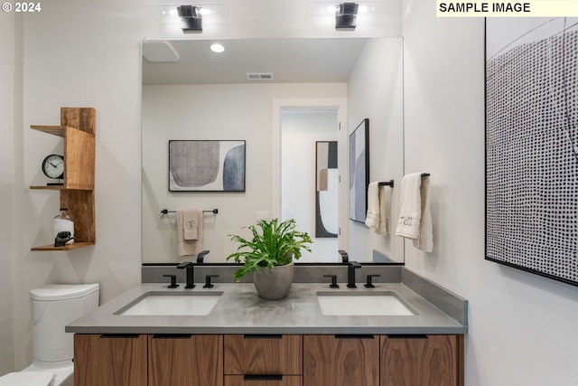 bathroom featuring vanity and toilet