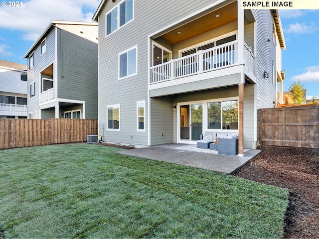 back of property featuring a balcony, an outdoor living space, a fenced backyard, a patio area, and a lawn