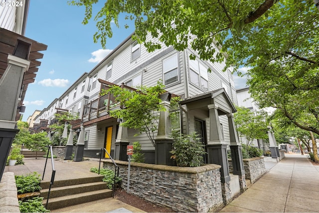 view of side of home featuring a balcony