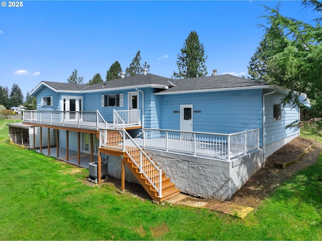 rear view of property featuring stairway, a wooden deck, a patio area, a lawn, and central AC unit
