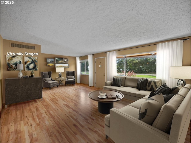 living area with wood finished floors and a textured ceiling