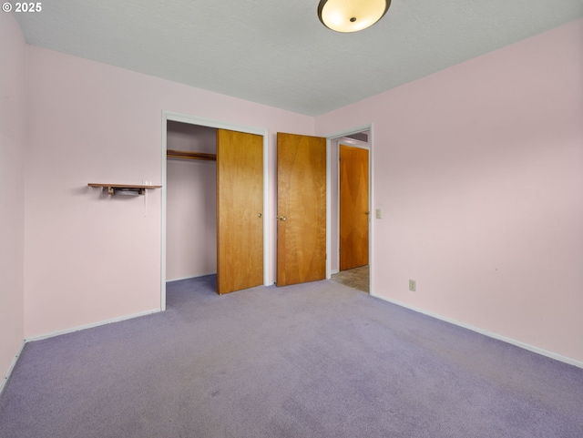 unfurnished bedroom featuring carpet flooring, a closet, and baseboards