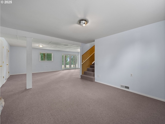 below grade area with stairs, carpet, and baseboards