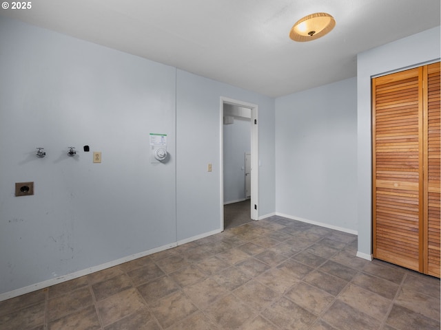 unfurnished bedroom with a closet and baseboards