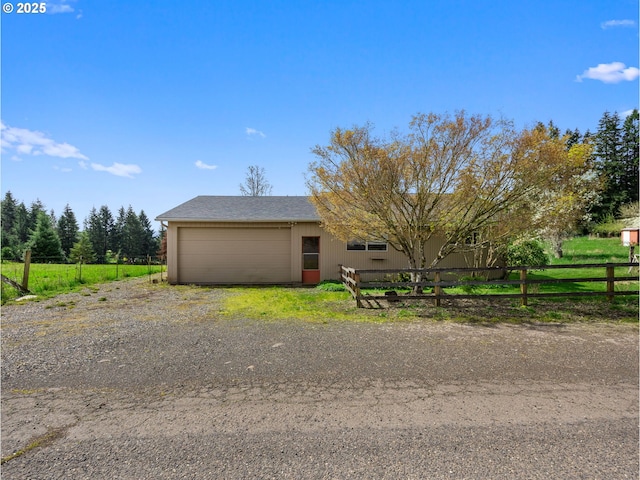 ranch-style home with fence and a garage